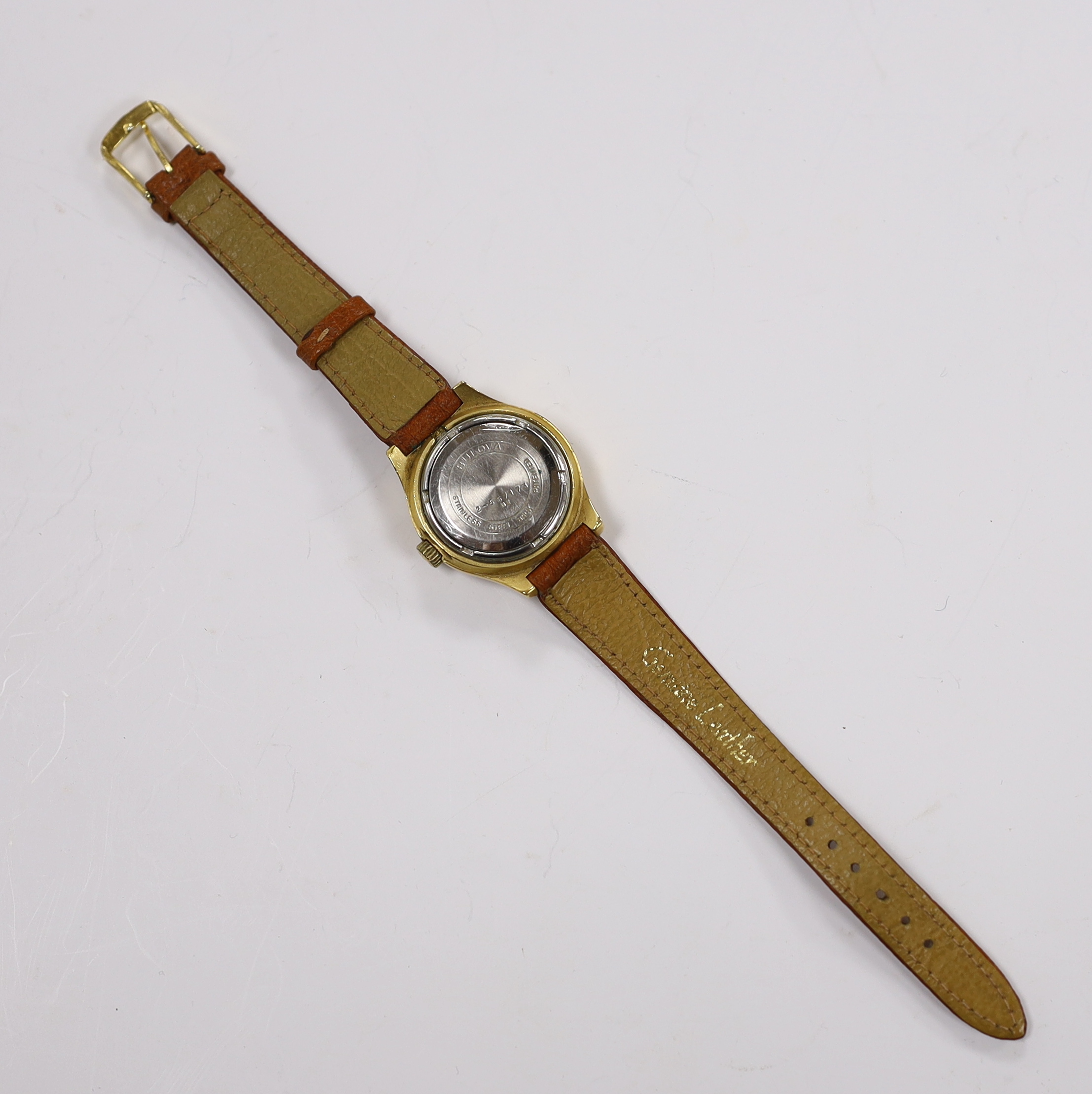 A lady's steel and gold plated Bulova Accutron wrist watch, on a leather strap.